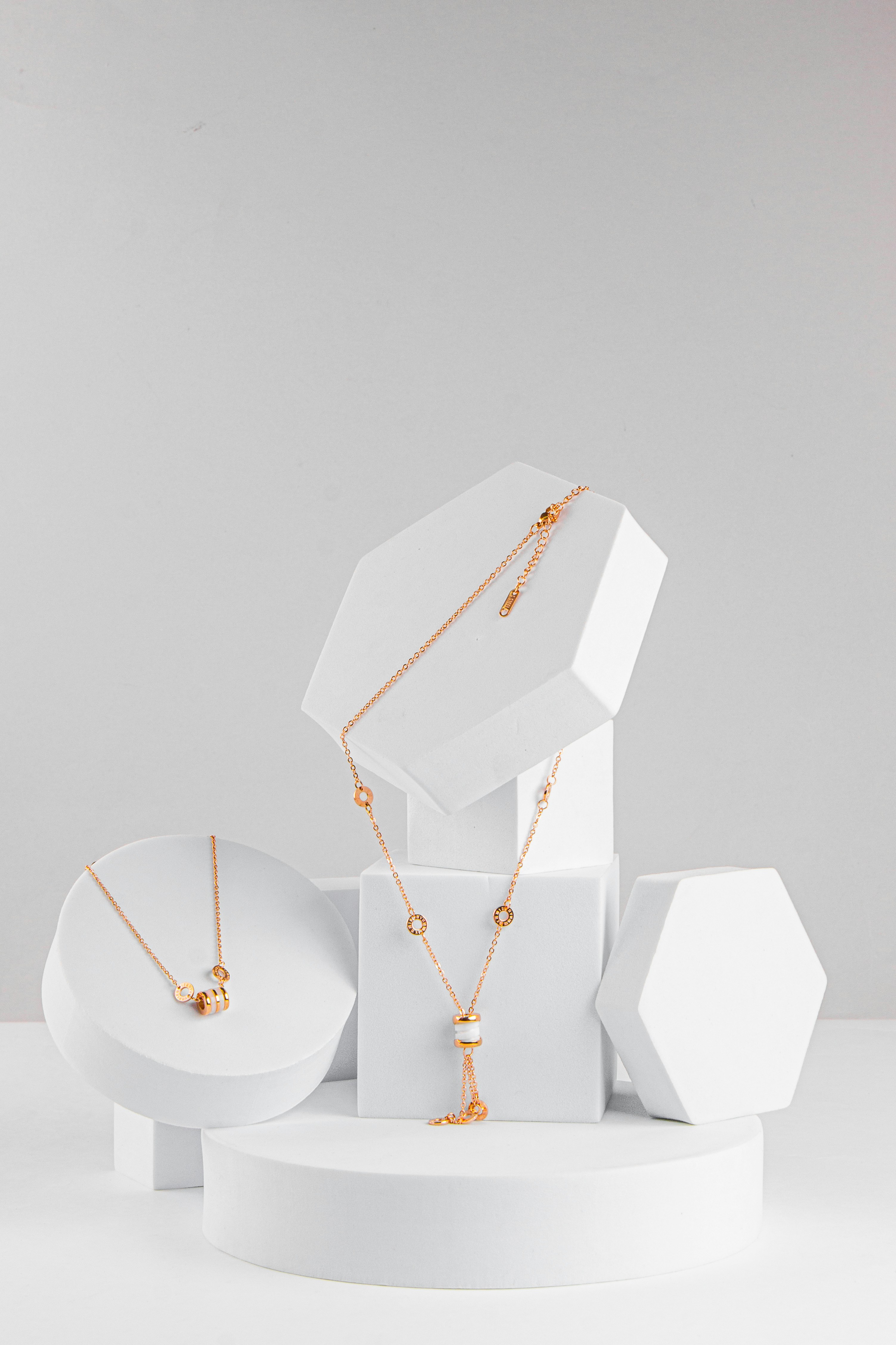 Gold necklace styled with orchids